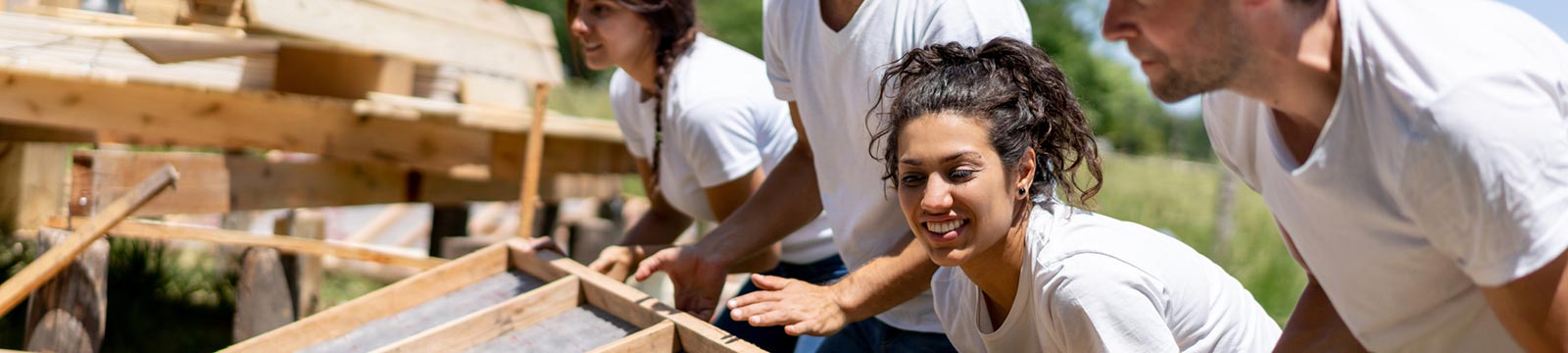 Young people building a house in the community