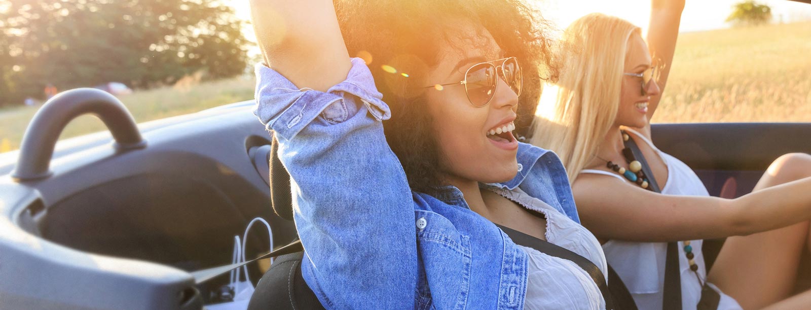 Two ladies riding in a new car