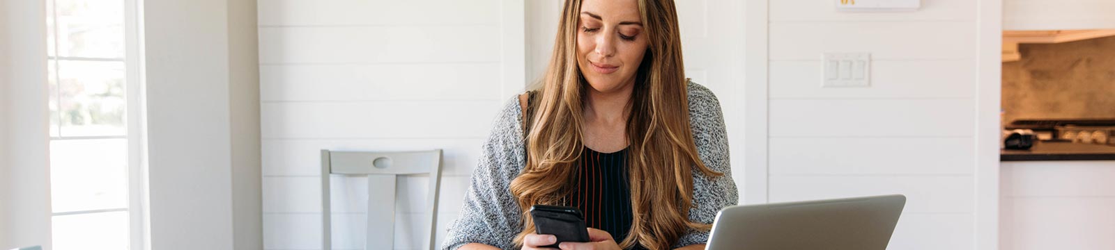 Lady using her smartphone at a desk