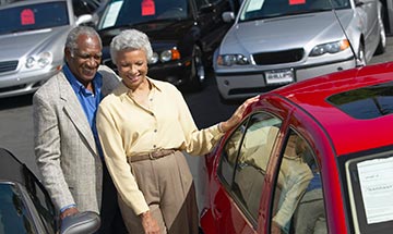 Older couple shopping for a new car